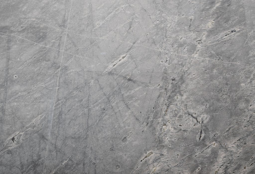 Close-up of a textured grey stone surface suitable for backgrounds or wallpapers.